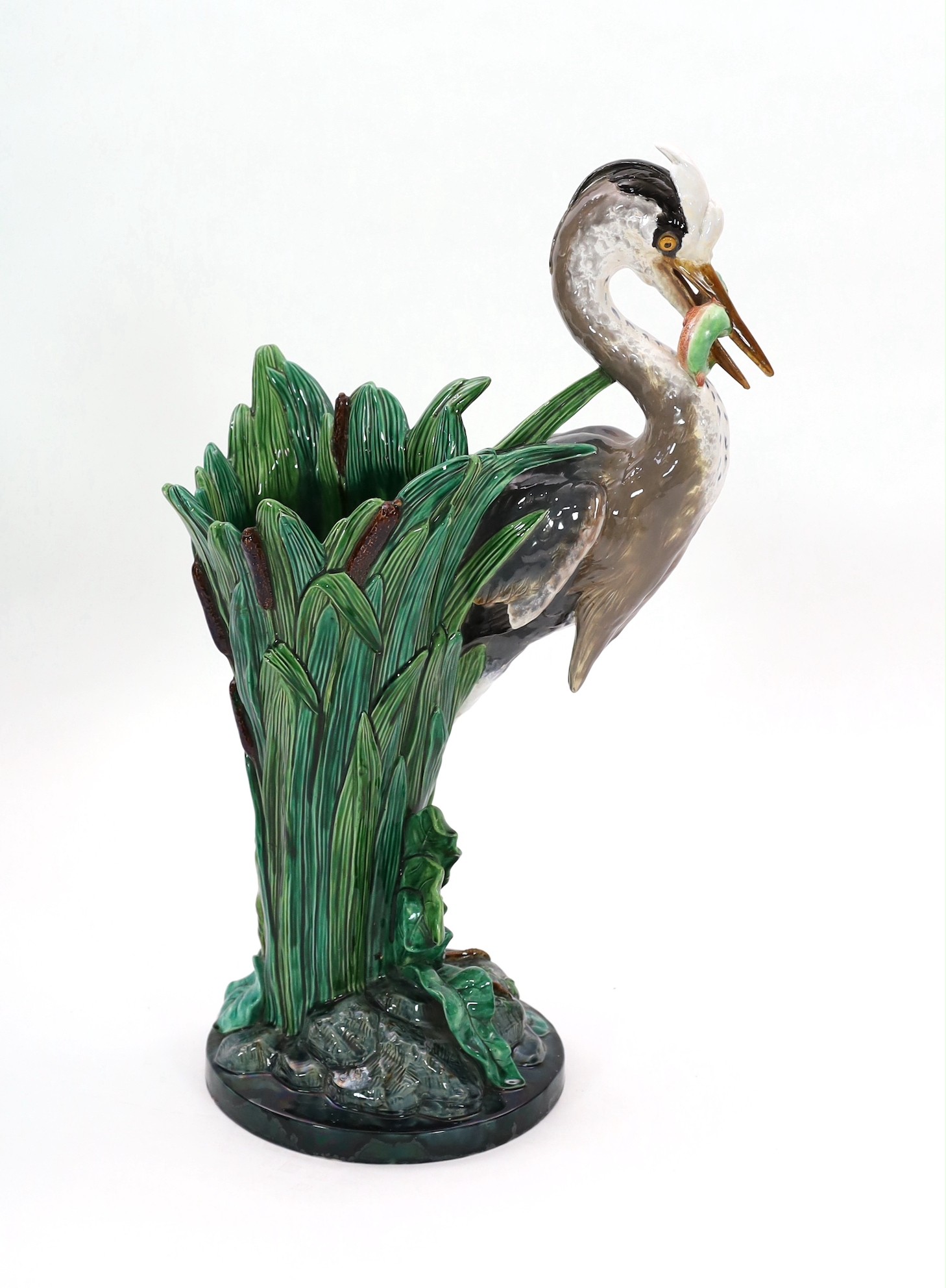 A Minton majolica life-size ‘heron’ stickstand, initialled J.H. for the modeller John Henk, c.1905, 44cm wide 76cm high